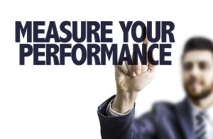 Business man pointing the text: Measure Your Performance